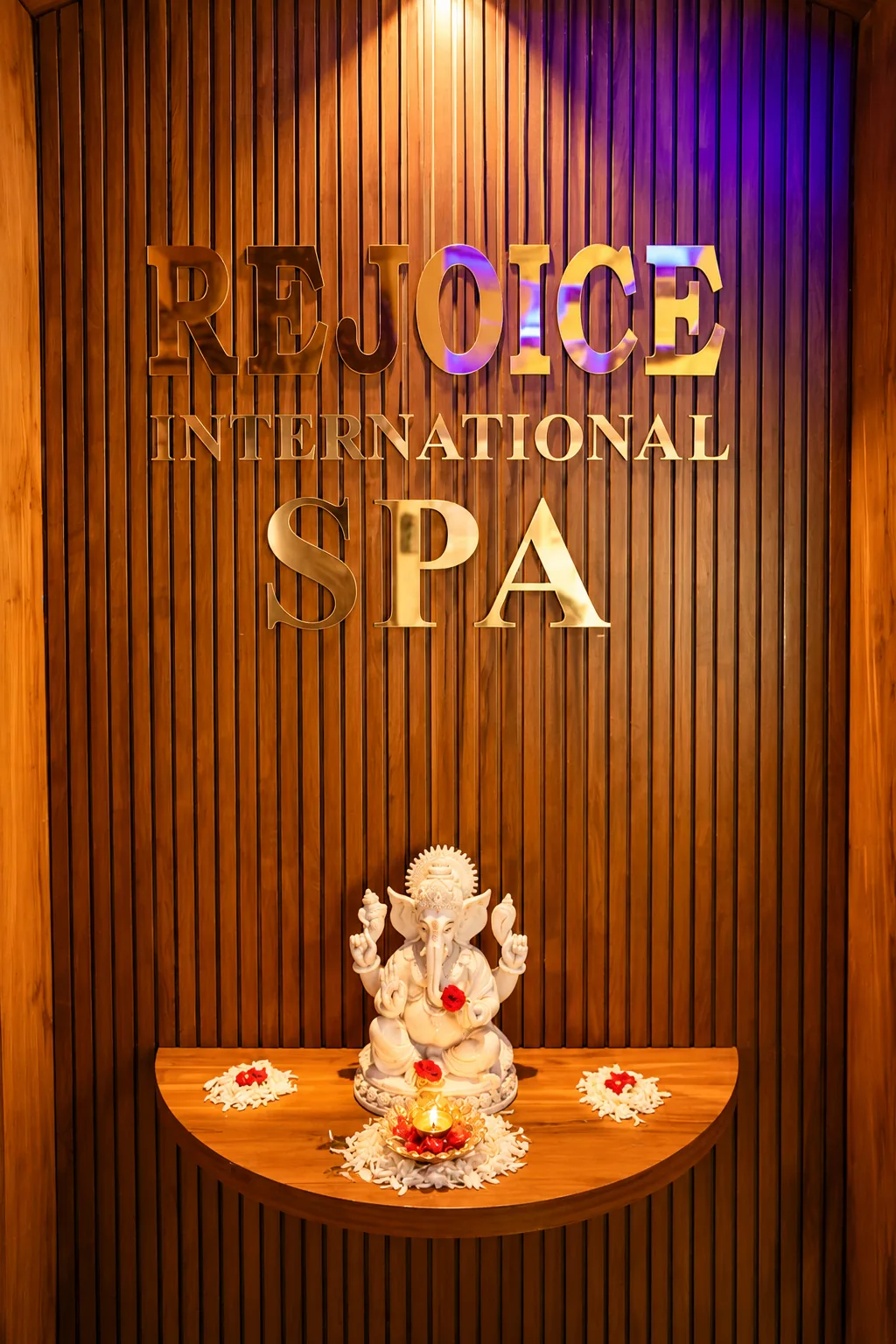 Wood-panelled Rejoice entrance display with Ganesha statue
